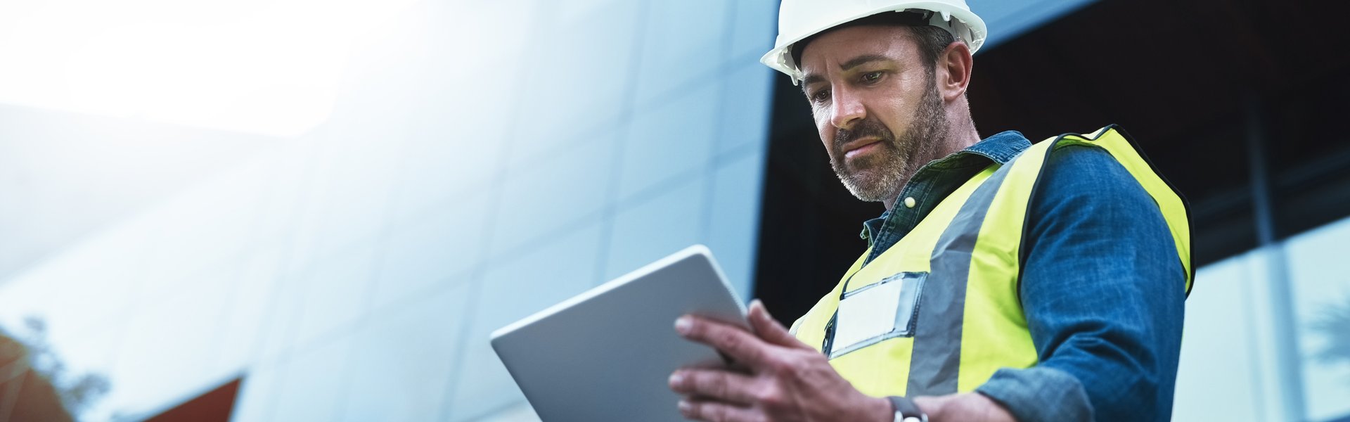 Daridam project managers reviewing site plans on a digital tablet