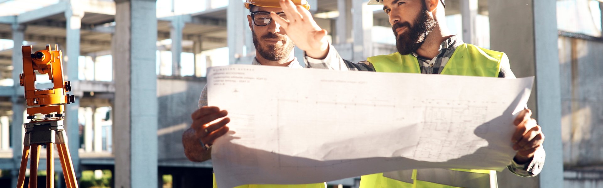 Qualified UK skilled tradesmen collaborating on a job site